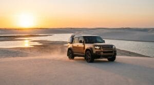 distância de Fortaleza até Jericoacoara — veículo 4x4 moderno atravessando as dunas sob o pôr do sol no litoral cearense